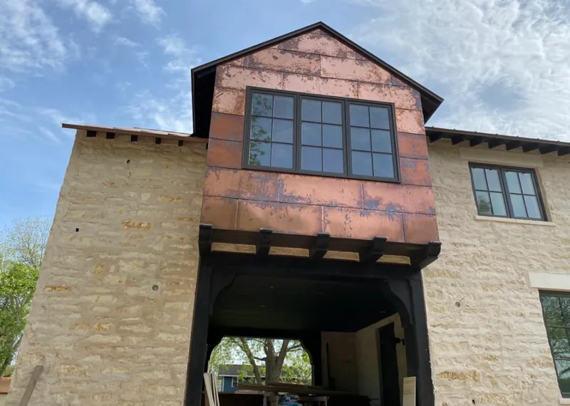 Copper metal panel facade on a stone building for Skylight Installation in Barstow